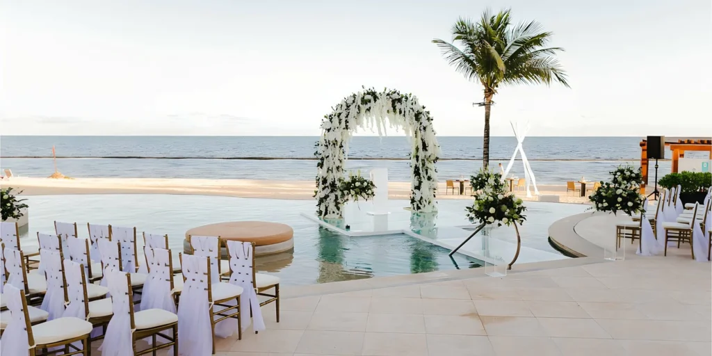 Over the Water wedding venue at Breathless Riviera Cancun with poolside ceremony seating