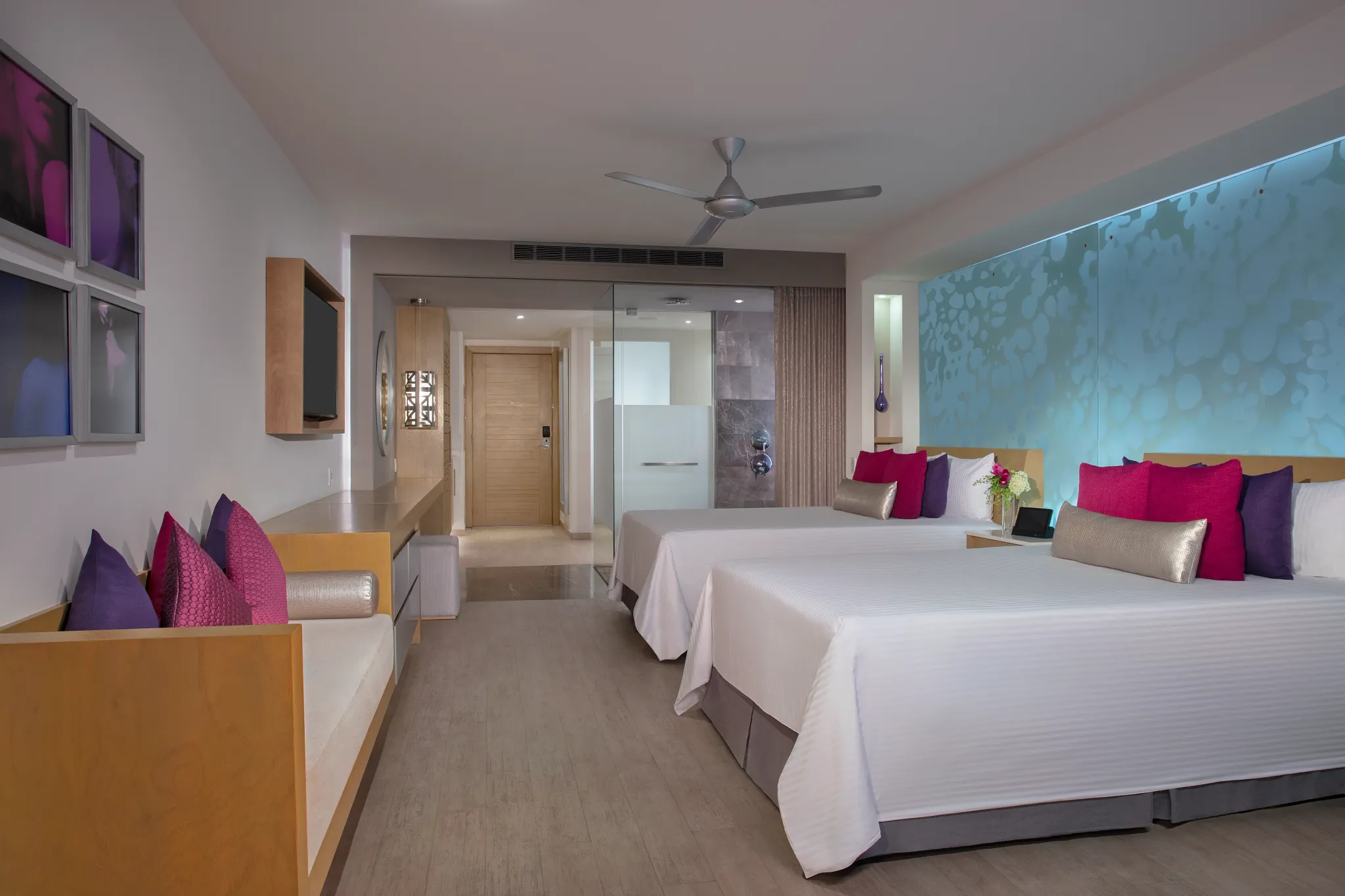 Spacious Allure Junior Suite Ocean View at Breathless Riviera Cancun with two beds, modern décor, accent lighting, and stylish seating.