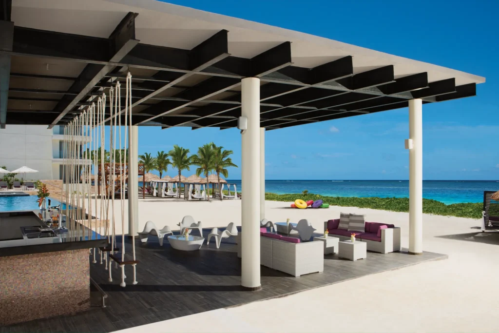 Beachfront Foam Bar at Breathless Riviera Cancun featuring swing seating, ocean views, and a relaxed tropical vibe.