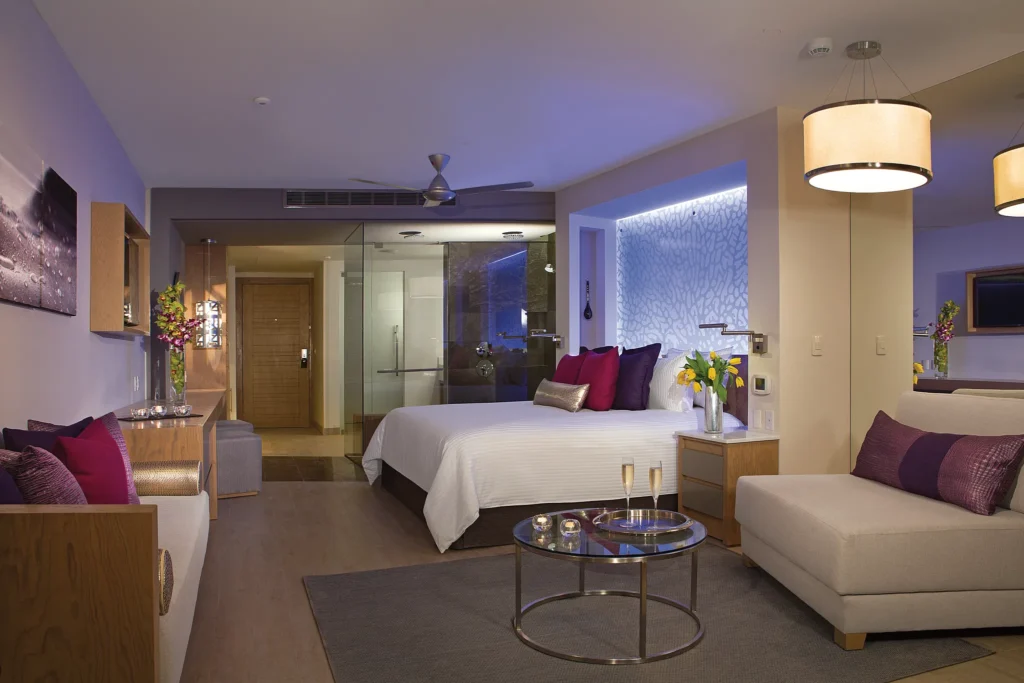 Xcelerate Junior Suite Swim-Out Ocean Front at Breathless Riviera Cancun featuring a king bed, modern seating area, stylish lighting, and direct swim-out access.
