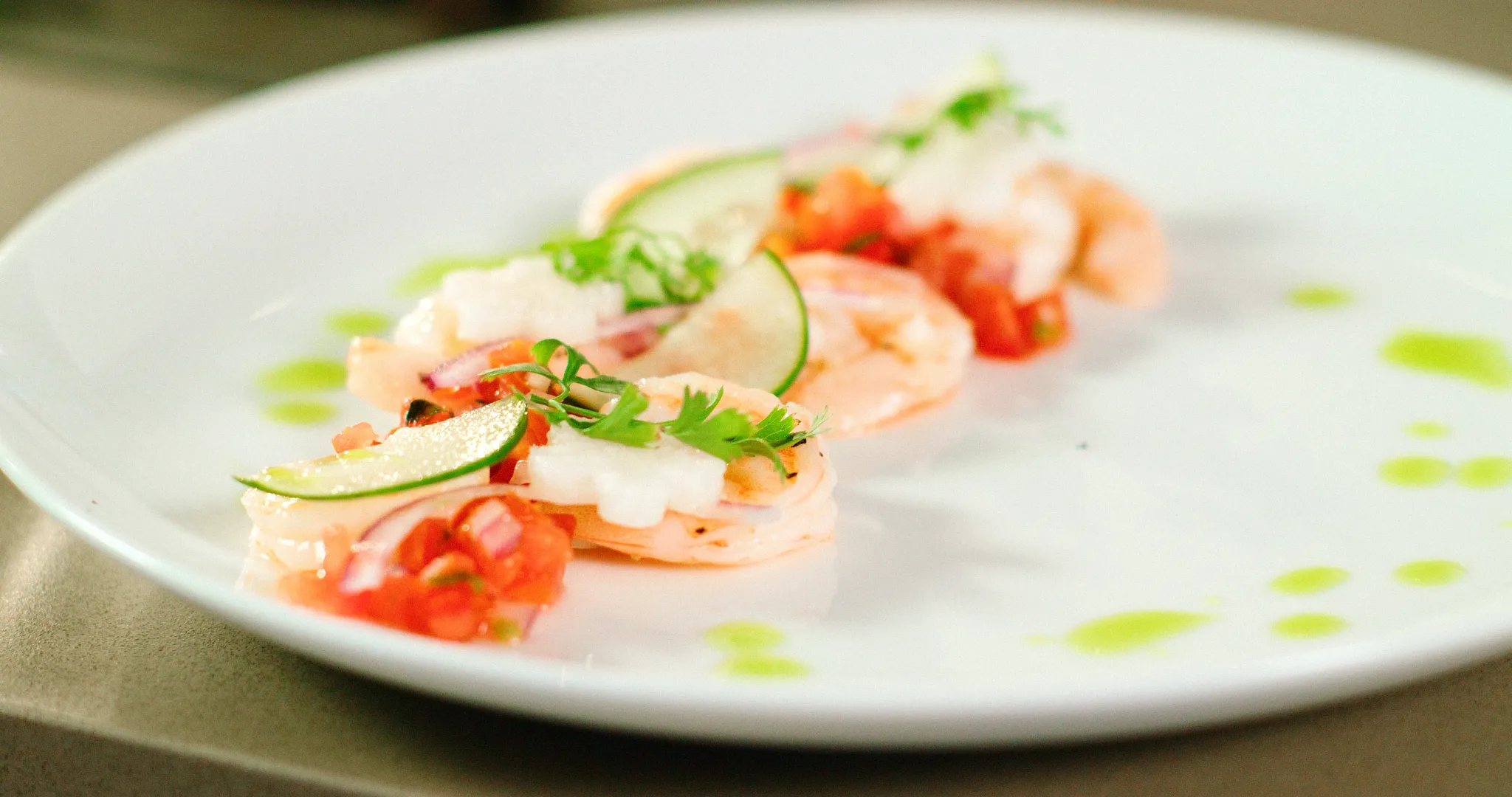 Gourmet shrimp appetizer with fresh lime, pico de gallo, and herbs at Breathless Cabo San Lucas.