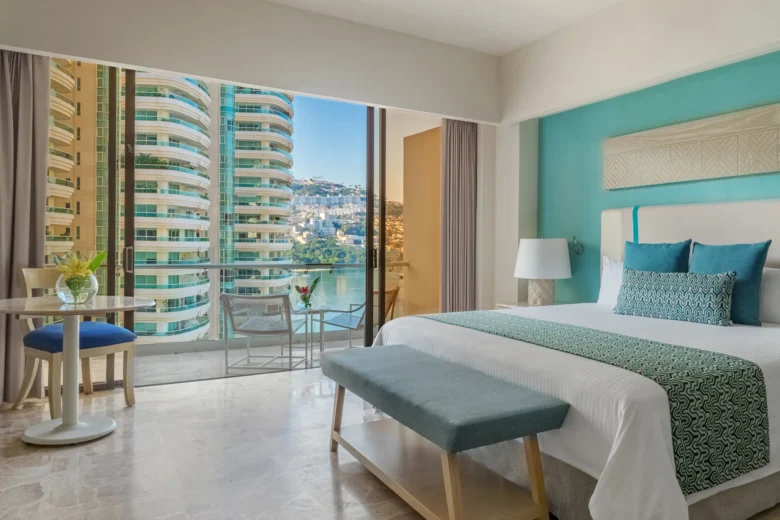 Deluxe Partial Ocean View room with king bed and balcony at Dreams Acapulco Resort & Spa.