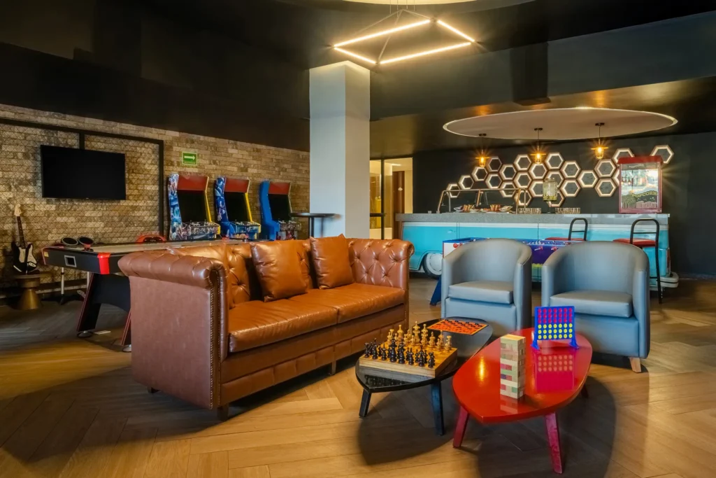 Indoor teen entertainment lounge with arcade games and seating at Dreams Acapulco Resort & Spa.