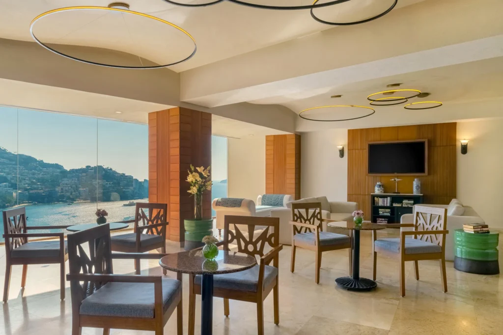 Elegant Preferred Club Lounge with ocean views at Dreams Acapulco Resort & Spa.
