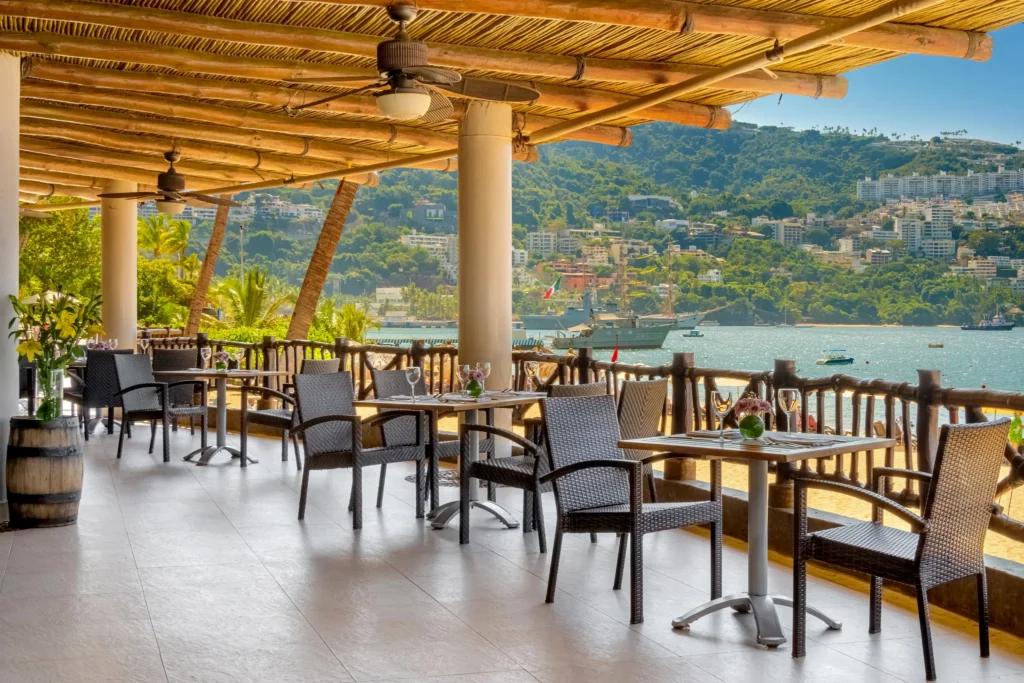 El Pescador Seafood Restaurant and Steakhouse at Dreams Acapulco Resort & Spa featuring oceanfront terrace dining with views of Acapulco Bay.