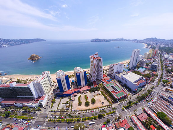 Playa Suites Acapulco Beach Resort oceanfront property with beachside pools and family-friendly accommodations on Acapulco's coastline.