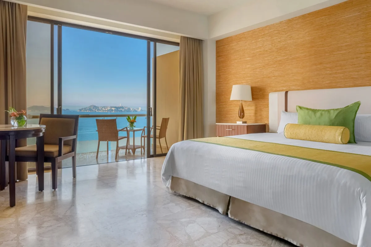 Preferred Club Deluxe Ocean View room with king bed and balcony at Dreams Acapulco Resort & Spa.
