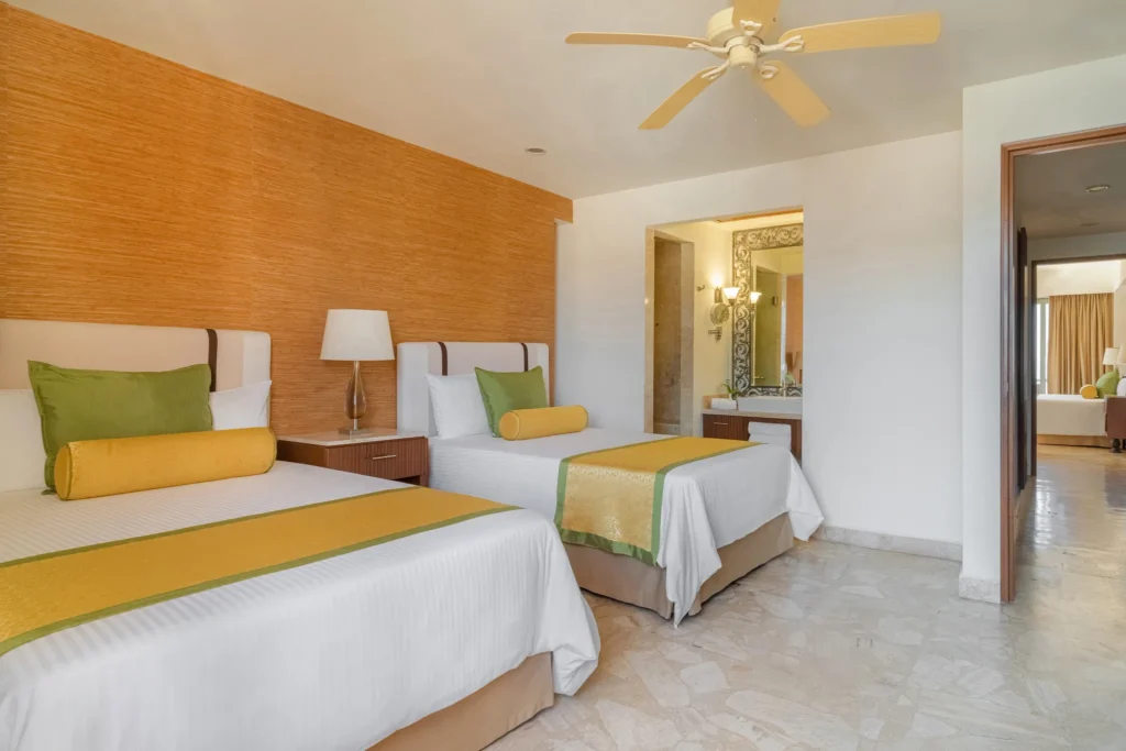 Preferred Club Family Suite Ocean View bedroom with two double beds at Dreams Acapulco Resort & Spa.