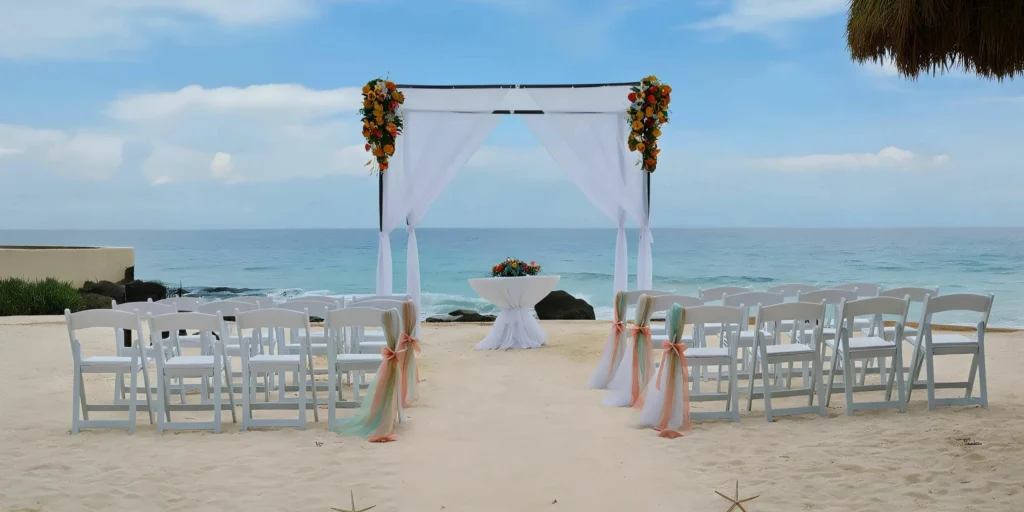 Beach ceremony setup with white chairs and ocean view at Central Beach Venue Dreams Aventuras Riviera Maya