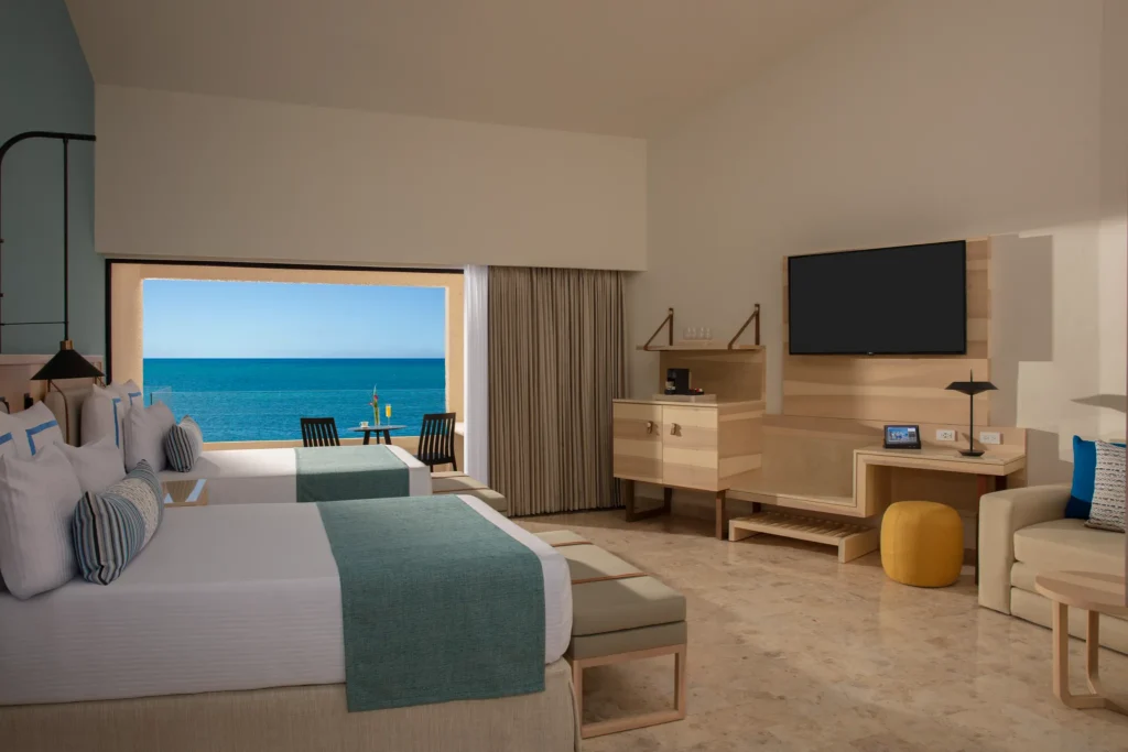Preferred Club Family Room Ocean Front with two double beds and balcony overlooking the Caribbean at Dreams Aventuras Riviera Maya.