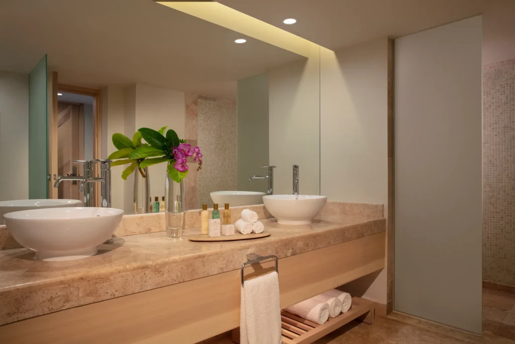 Preferred Club Honeymoon bathroom with double vessel sinks and modern vanity at Dreams Aventuras Riviera Maya.