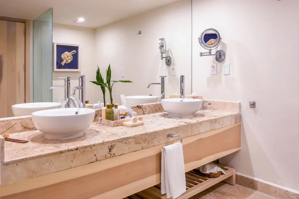 Preferred Club Marina View bathroom with double vessel sinks and modern vanity at Dreams Aventuras Riviera Maya.