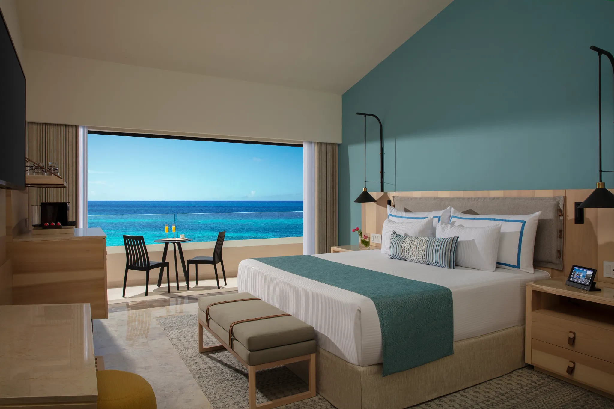 Preferred Club Master Two Bedroom Suite Ocean Front with king bed and balcony overlooking the Caribbean at Dreams Aventuras Riviera Maya.