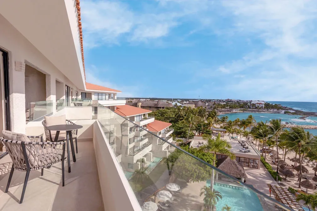 Preferred Club Ocean View balcony with seating overlooking beach and ocean at Dreams Aventuras Riviera Maya.