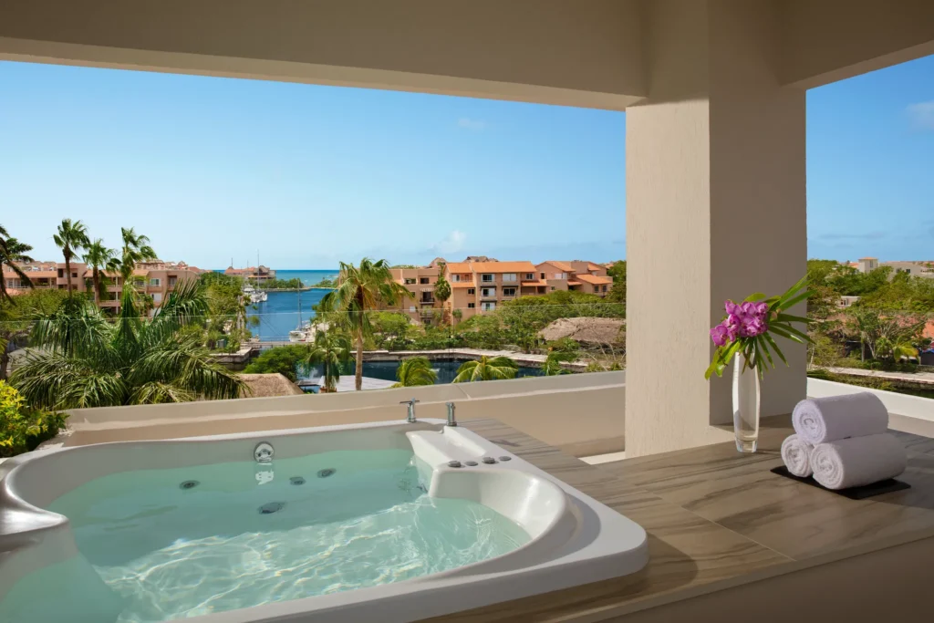 Preferred Club Premium Suite terrace with hot tub and marina view at Dreams Aventuras Riviera Maya.