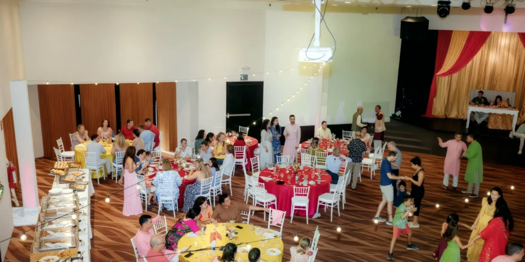 Indoor theater venue reception setup with stage at Dreams Aventuras Riviera Maya