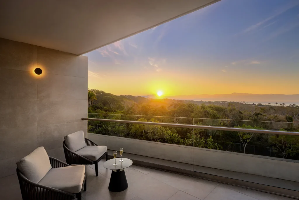 Sunset view from private balcony with seating at Junior Suite Tropical View Dreams Bahia Mita Surf & Spa Resort.