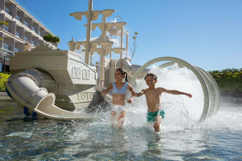 Children playing in a pirate-themed water park with slides and splash features at Dreams Bahia Mita.