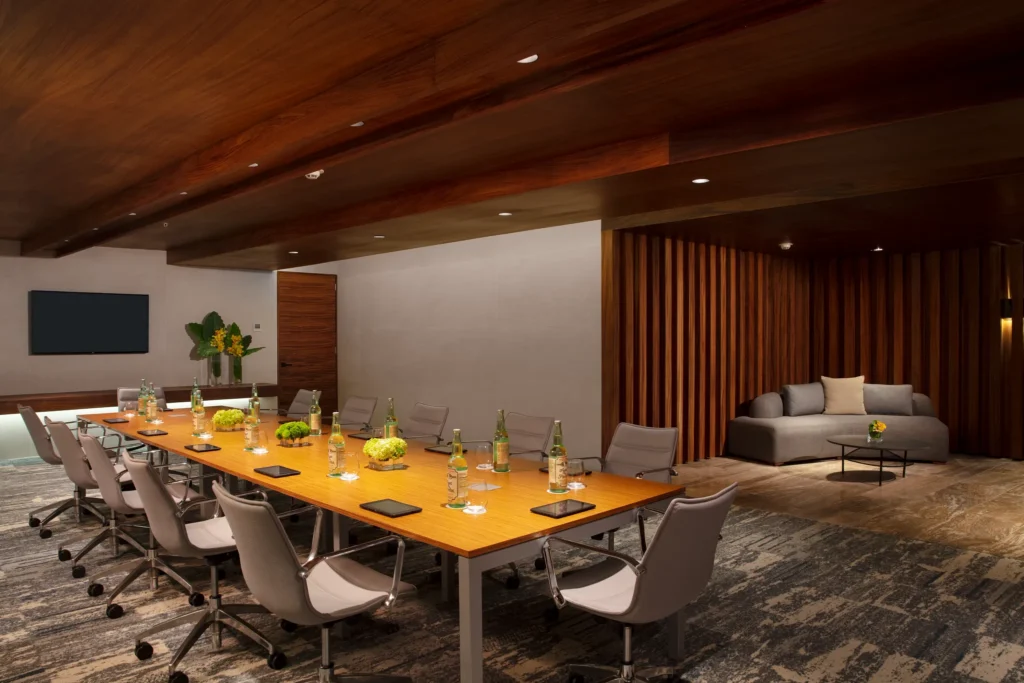 Modern meeting room with conference table, chairs, and refreshments at Dreams Bahia Mita.