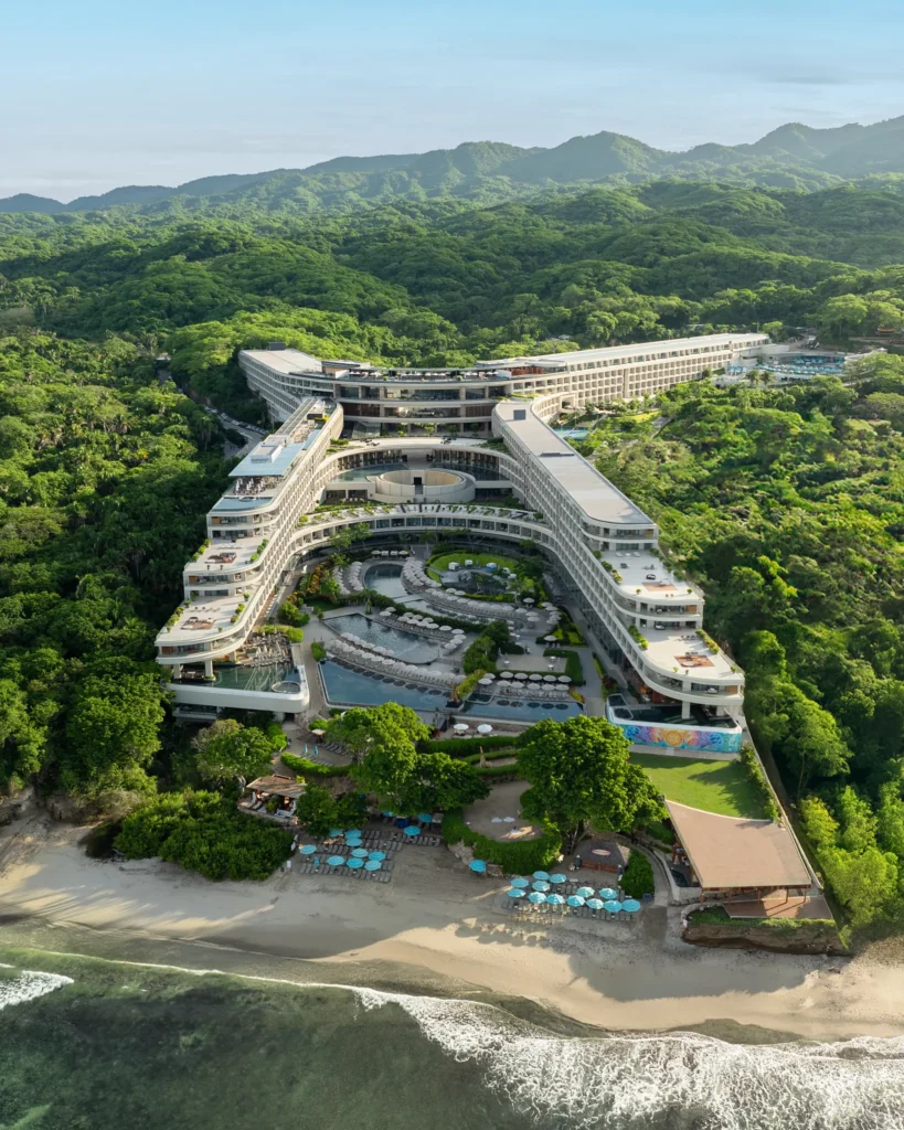 Elevated aerial view of Dreams Bahia Mita with pools, terraces, and jungle surroundings.