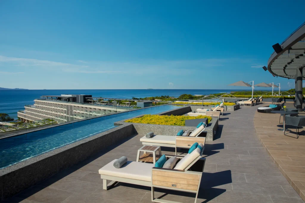 Sky Bar at Dreams Bahia Mita Surf & Spa Resort featuring rooftop views, stylish lounge seating, and sunset cocktails overlooking the ocean.