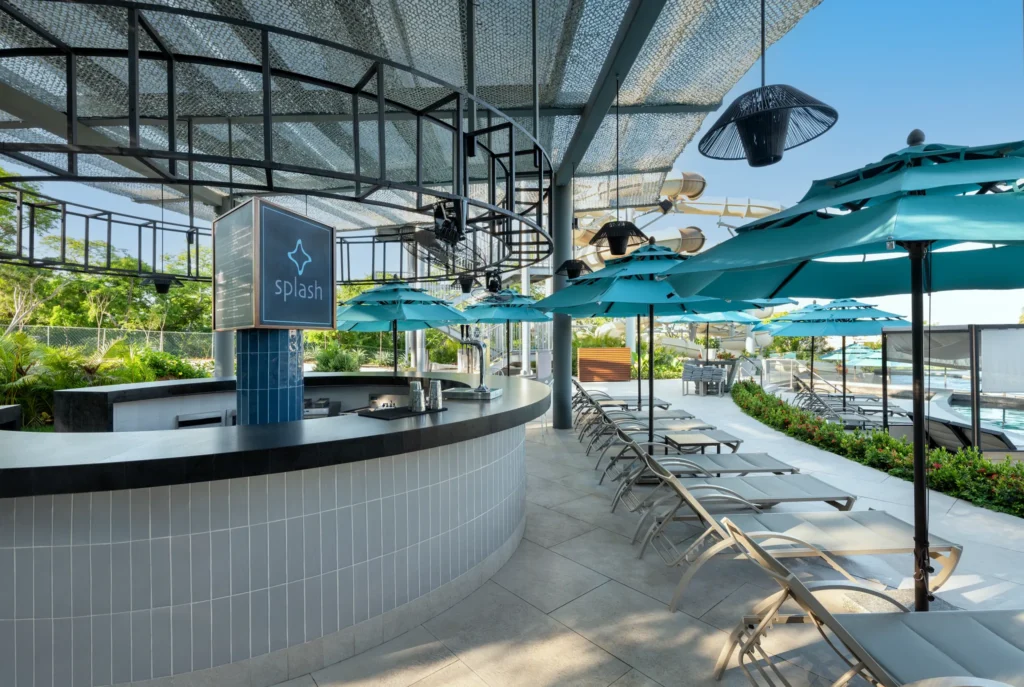 Splash water park bar at Dreams Bahia Mita Surf & Spa Resort featuring family-friendly drinks, poolside service, and a fun aquatic play area.