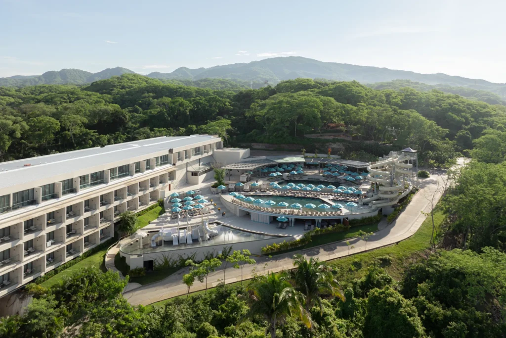 Aerial view of water park with slides and pools at Dreams Bahia Mita resort.