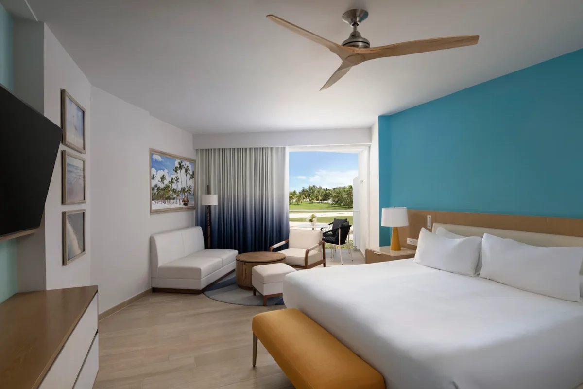 Deluxe Garden View room with king bed, sitting area, and balcony at Dreams Cap Cana Resort & Spa.