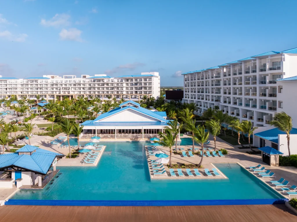 Infinity-edge pool overlooking tropical resort grounds at Dreams Cap Cana Resort & Spa.
