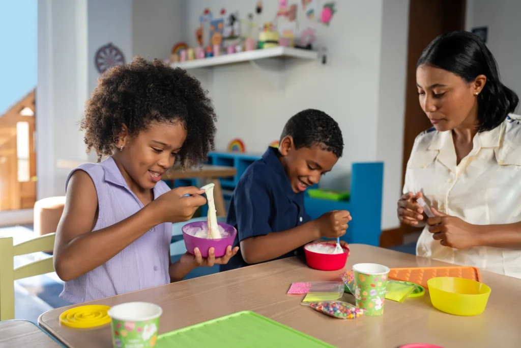 Kids making crafts with a staff member at Explorer’s Club at Dreams Cap Cana Resort & Spa.