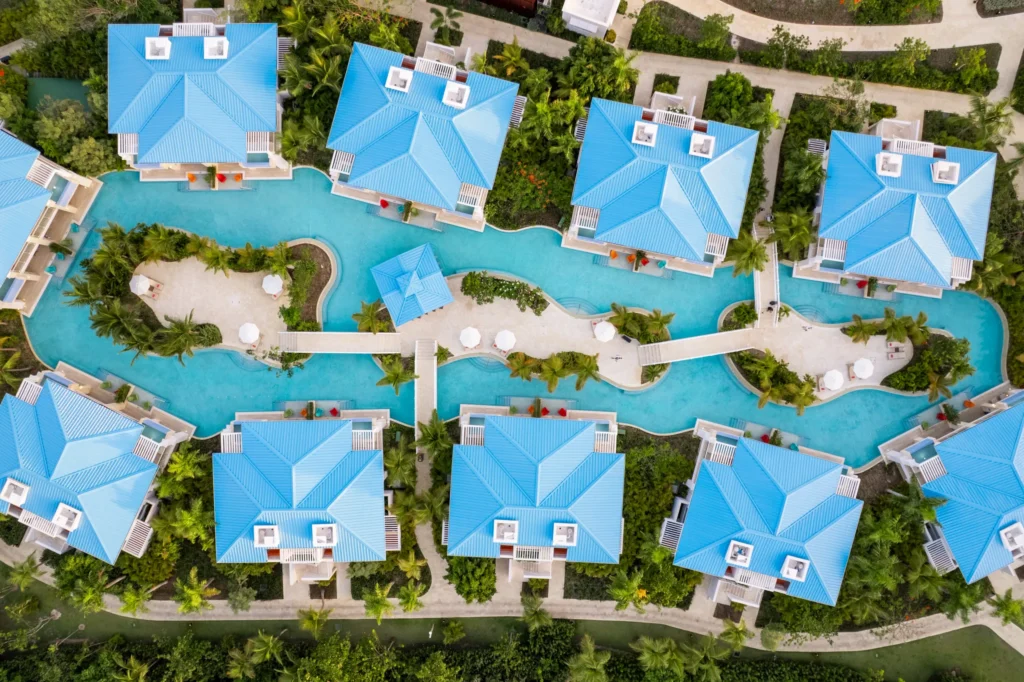 Overhead view of lagoon-style pool winding through villas at Dreams Cap Cana Resort & Spa.