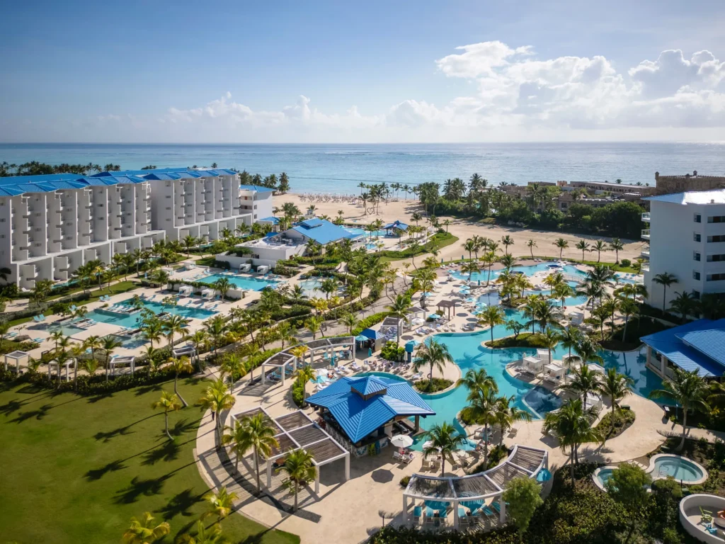 Elevated view of main pool area with ocean in the background at Dreams Cap Cana Resort & Spa.