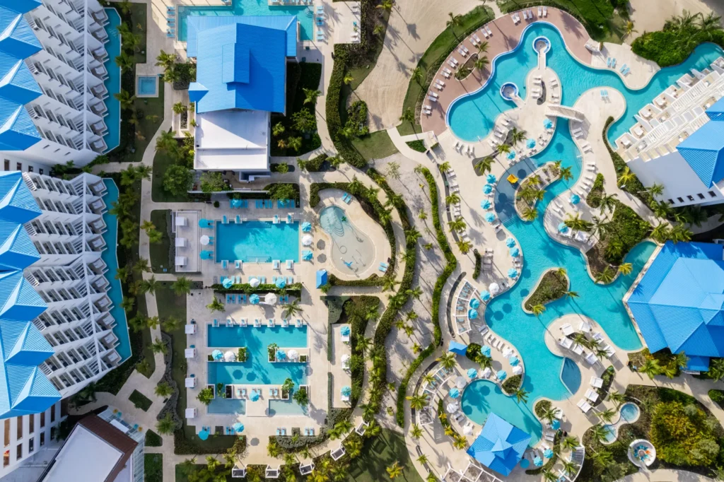 Aerial view of multiple pools and palm-lined pathways at Dreams Cap Cana Resort & Spa.