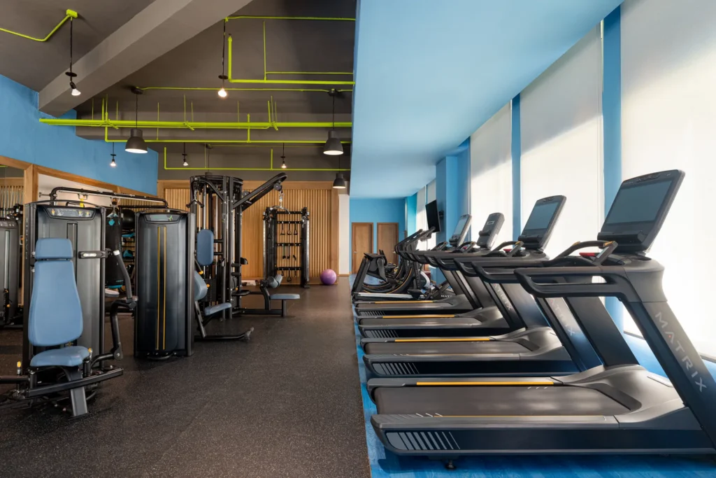 Modern fitness center with treadmills and weight machines at Dreams Cap Cana Resort & Spa.