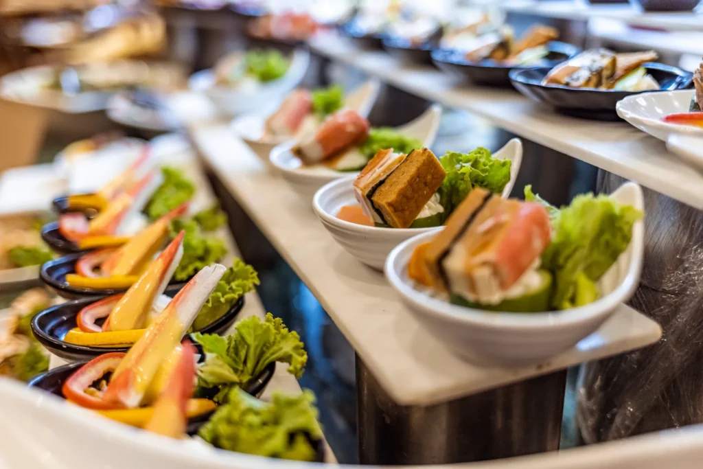 Mesa Central Kitchen restaurant at Dreams Cap Cana Resort & Spa featuring a contemporary buffet, open kitchen stations, and elegant casual dining atmosphere.
