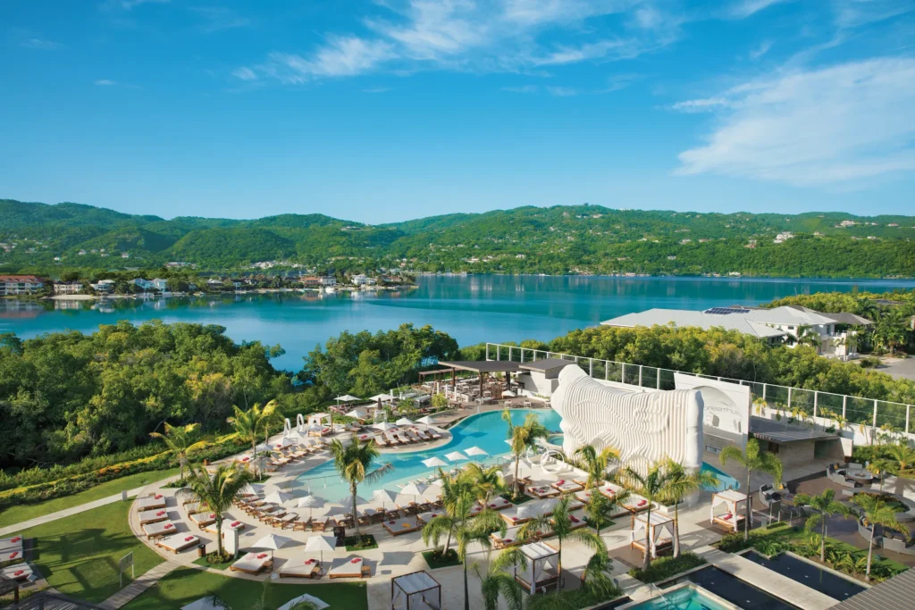 Aerial view of the luxury pool at Breathless Montego Bay Resort & Spa overlooking turquoise Caribbean waters.