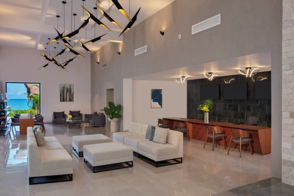 Modern open-air lobby at Dreams Cozumel Cape Resort & Spa with contemporary seating and ocean views.