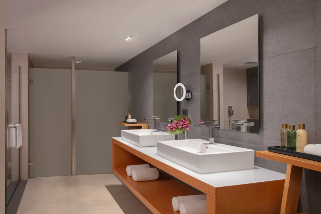 Master Suite Ocean View bathroom with double vanity and modern shower at Dreams Cozumel Cape Resort & Spa.