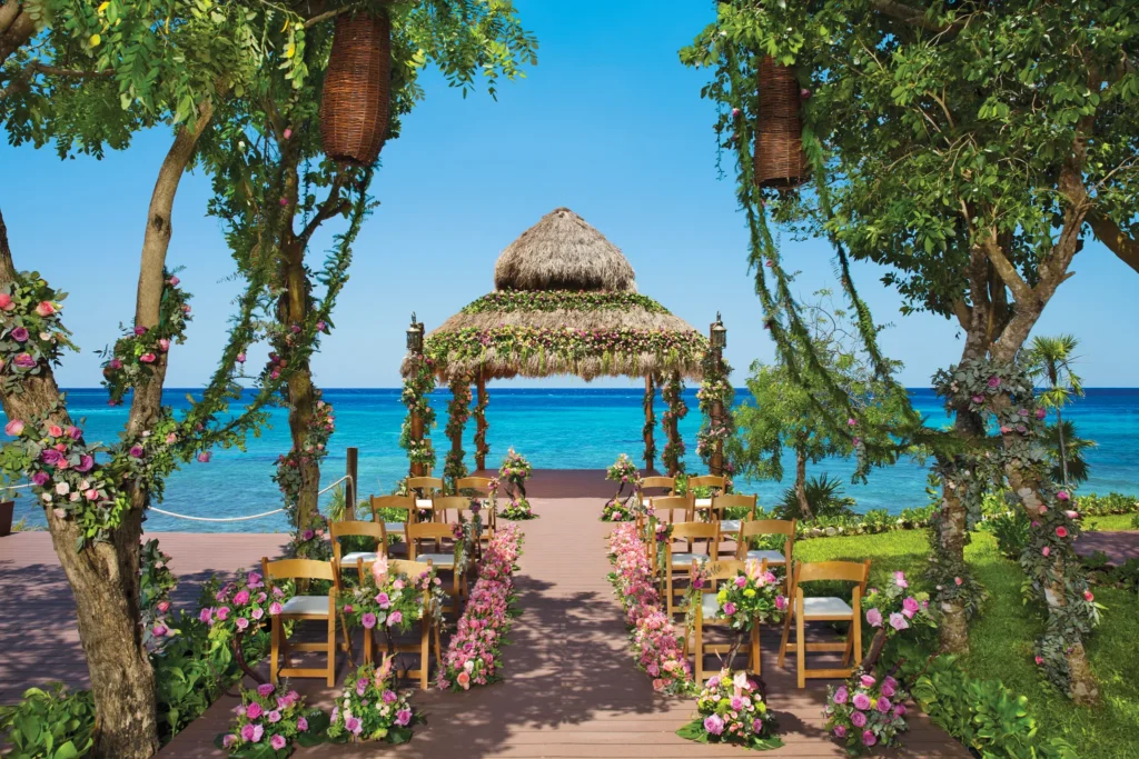 Oceanfront gazebo wedding ceremony with floral aisle at Dreams Cozumel Cape