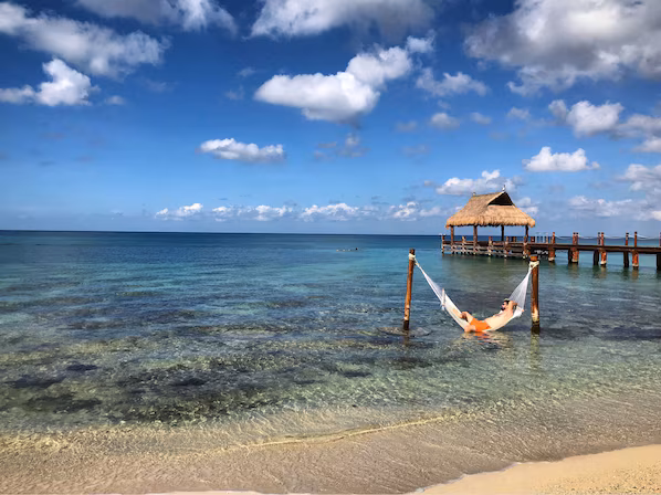 Paradise Beach near Dreams Cozumel Cape Resort & Spa with white sand shoreline and clear turquoise Caribbean waters