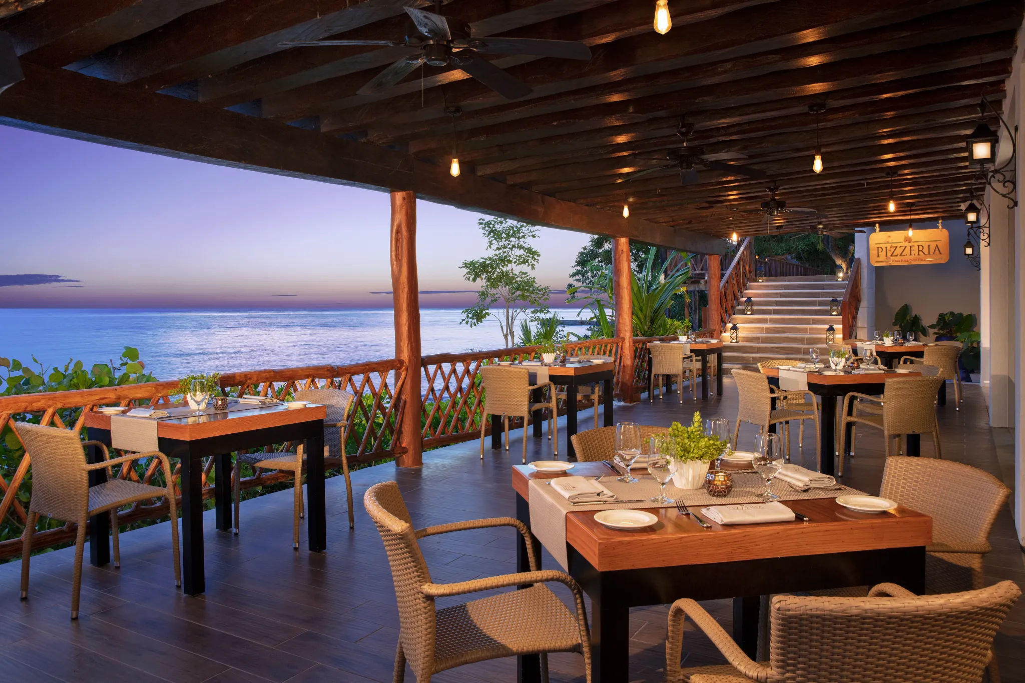 Pizzeria Italian trattoria at Dreams Cozumel Cape Resort & Spa featuring oceanfront terrace dining and sunset views.