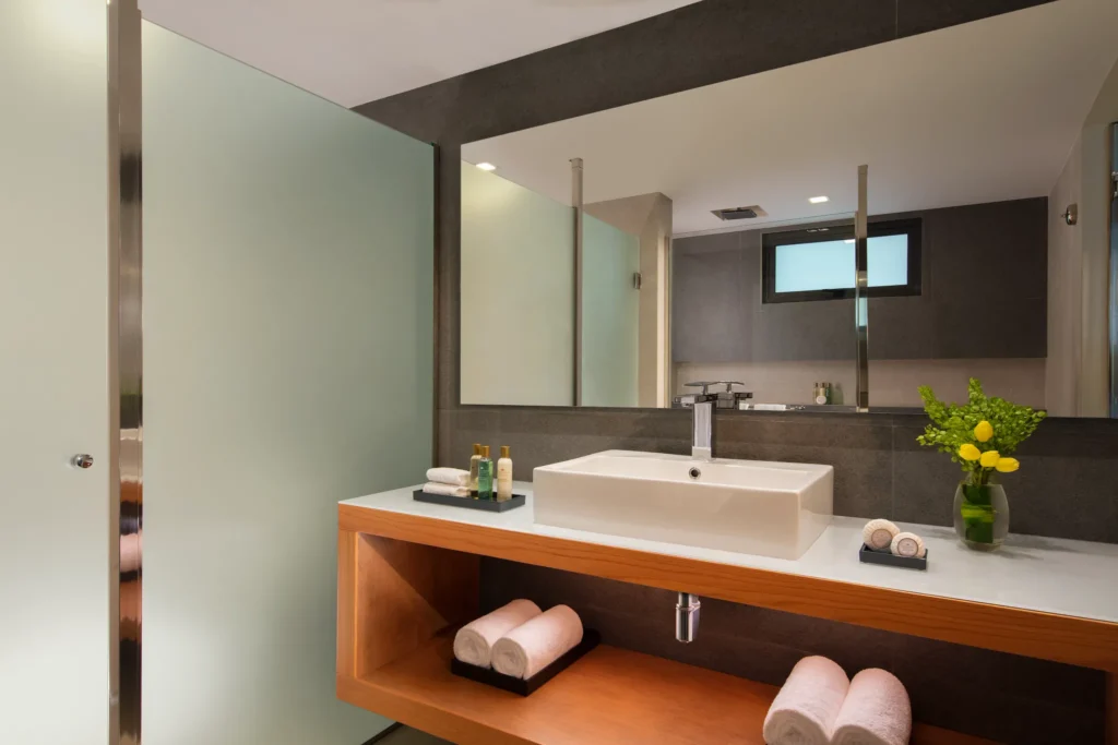 Modern bathroom with sleek vanity and glass shower in Preferred Club Junior Suite Ocean Front at Dreams Cozumel Cape.