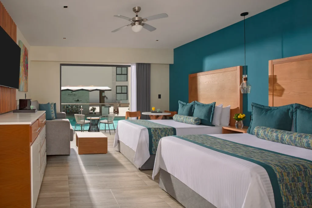 Preferred Club Junior Suite Pool View with two queen beds and balcony at Dreams Cozumel Cape Resort & Spa.