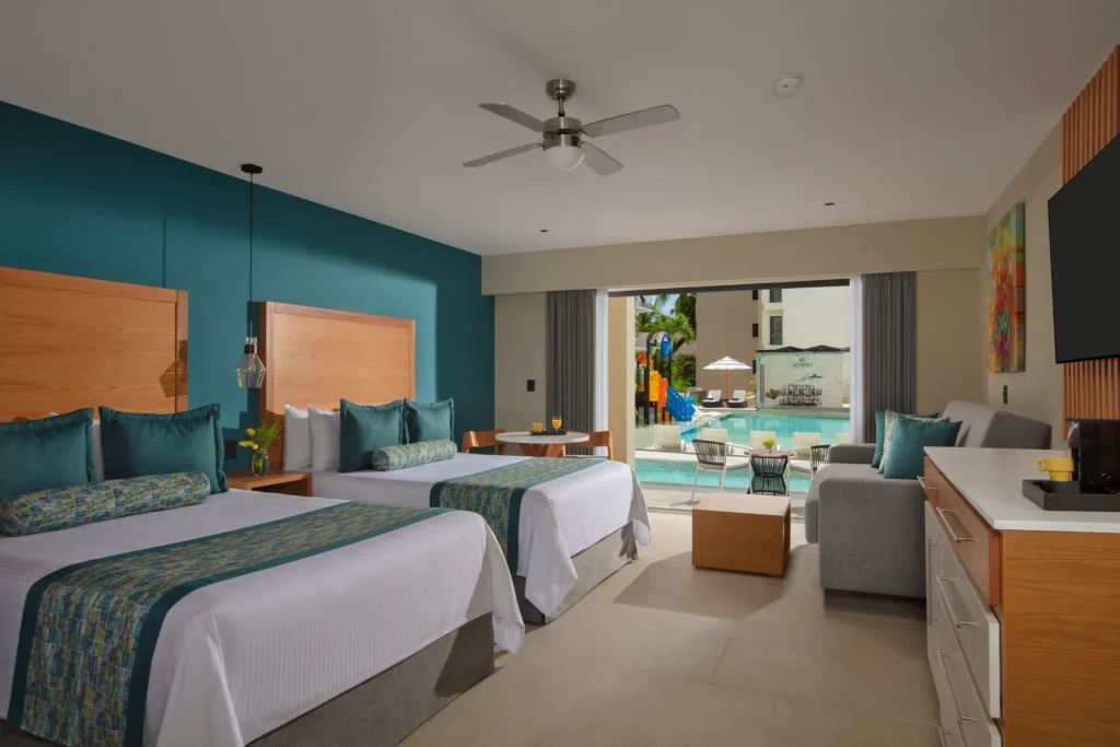 Preferred Club Junior Suite Swim Out Pool View with two queen beds and direct pool access at Dreams Cozumel Cape Resort & Spa.