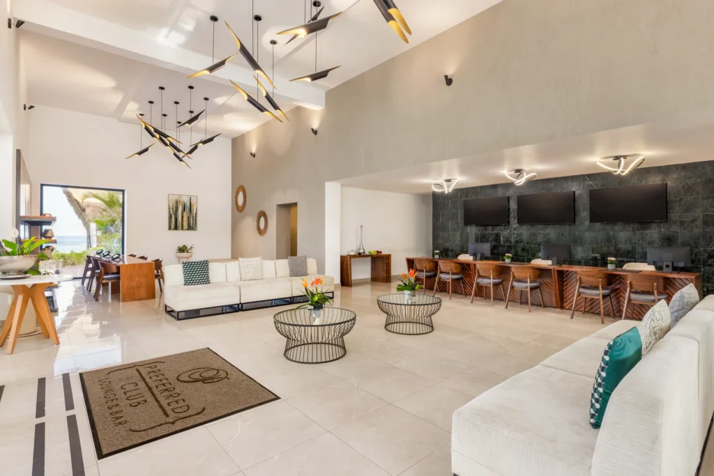 Preferred Club lounge seating area at Dreams Cozumel Cape Resort & Spa with concierge desk and premium amenities.