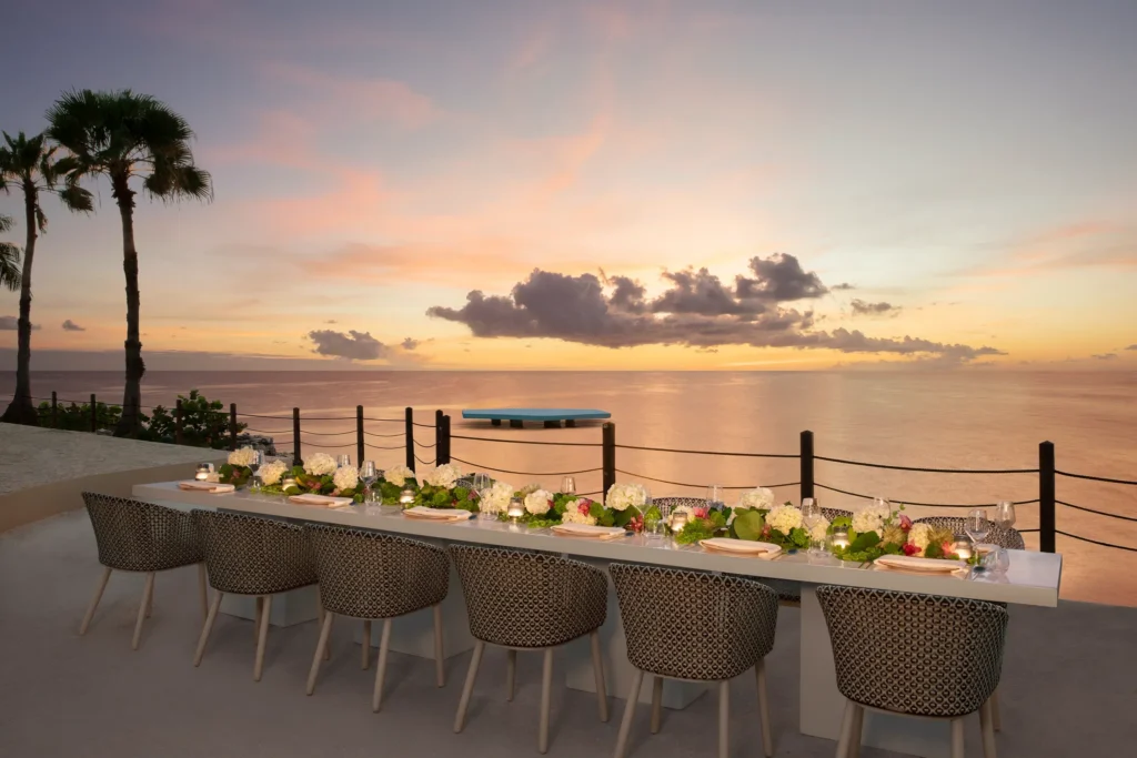 Elegant beachfront dinner reception setup at sunset at Dreams Curaçao Resort.