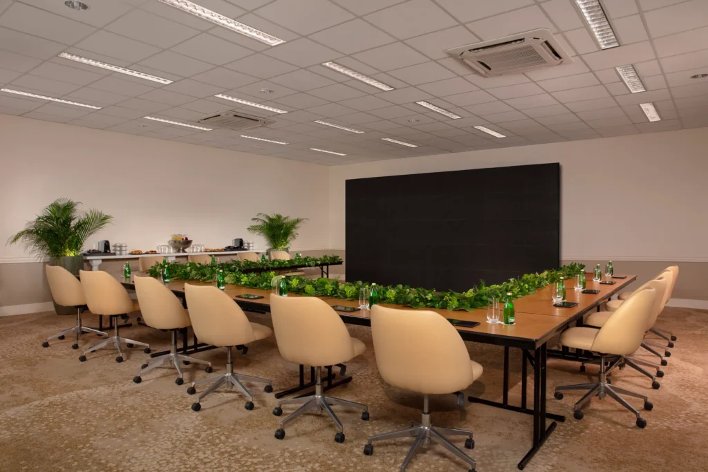 Conference room with long table and presentation screen at Dreams Curaçao Resort.