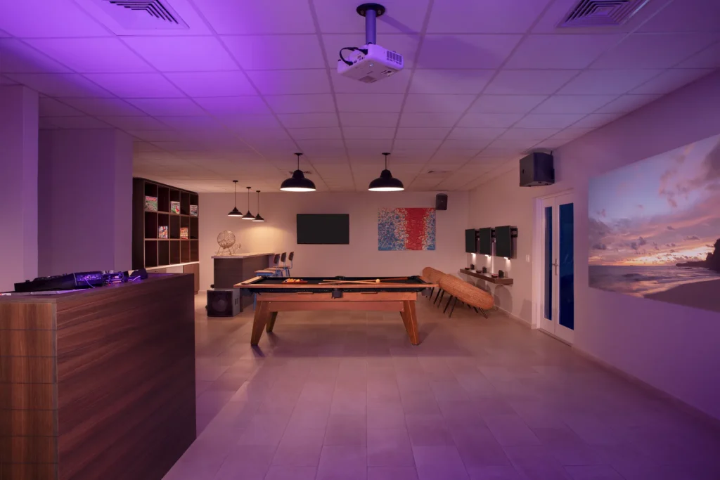 Teen entertainment lounge with pool table, gaming area, and modern lighting at Dreams Curaçao Resort.