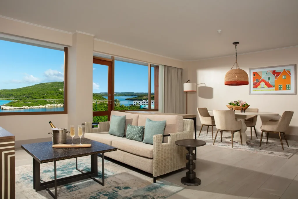 Preferred Club Presidential Suite living and dining area with ocean view at Dreams Curaçao Resort.
