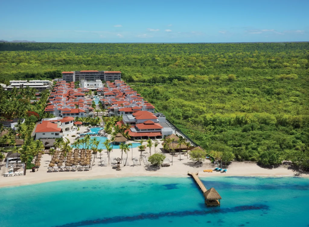 Aerial view of Dreams Dominicus La Romana beachfront resort and turquoise Caribbean waters.